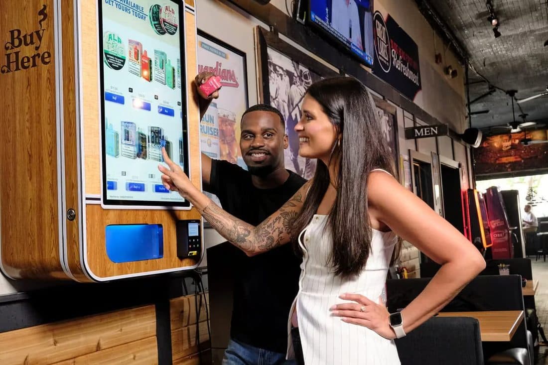 Customers using a VTM touchscreen unit installed in a casual venue
